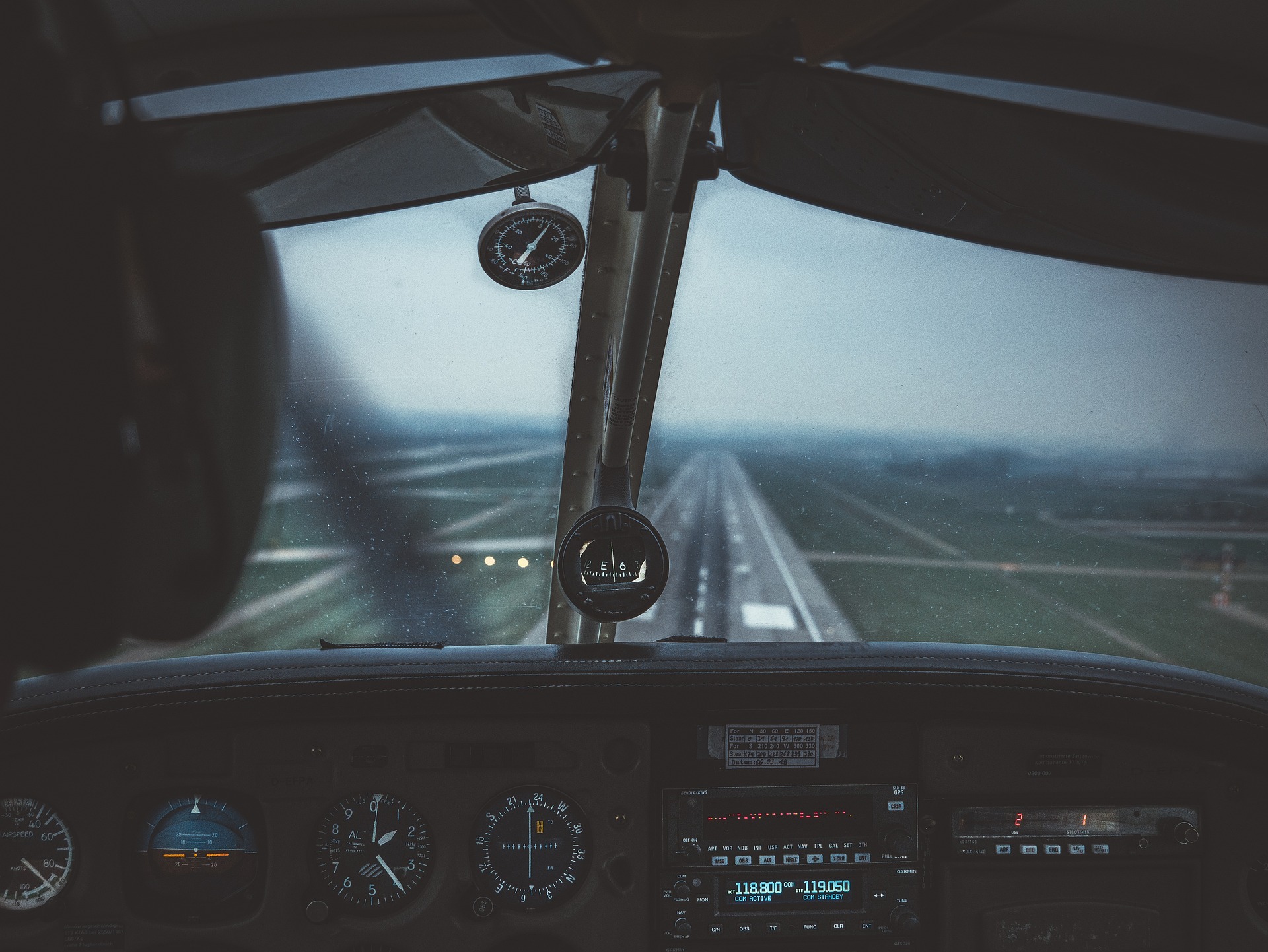 View inside of the cockpit of an aircraft taking off.