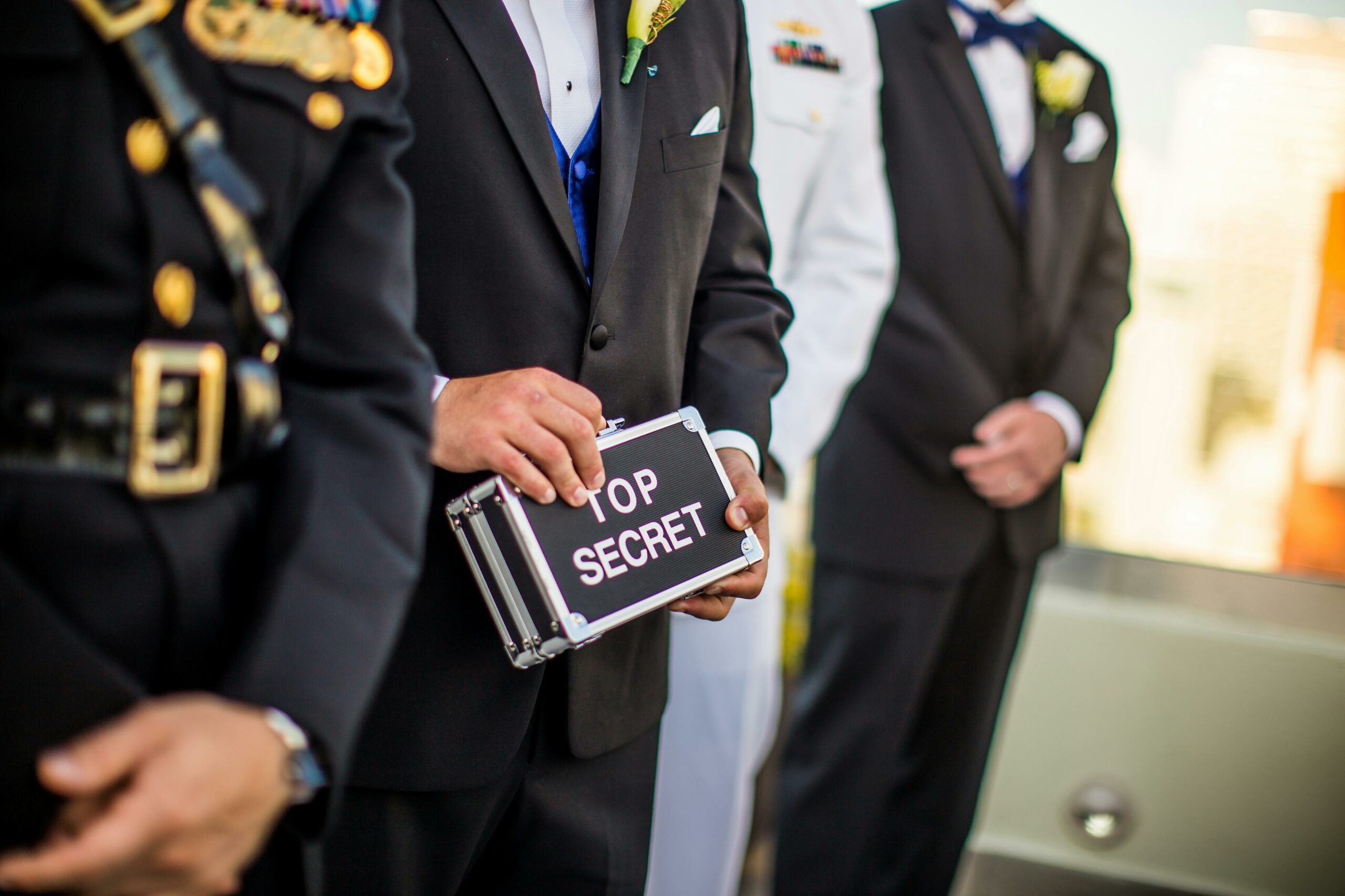 Man holding a box with labeled as top secret.