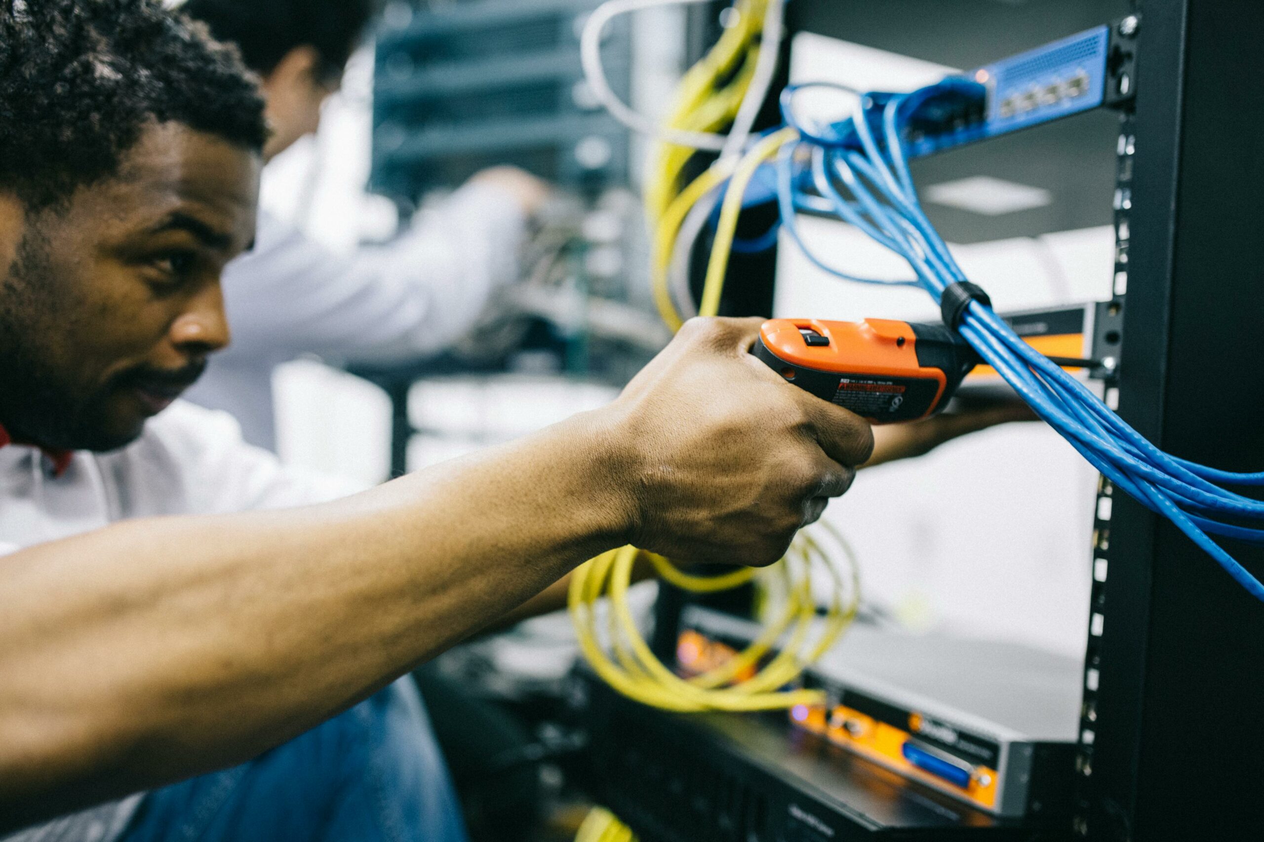 Engineers installing equipment on a rack.