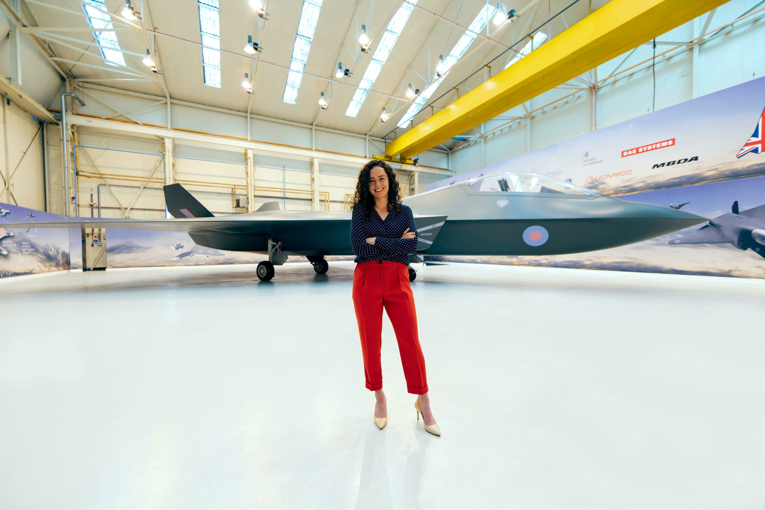 Female aerospace engineer in front of a jet.